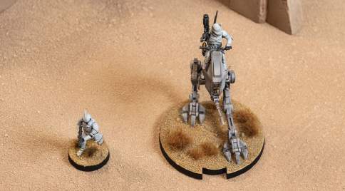a clone trooper and an at-rt, each with different sized bases